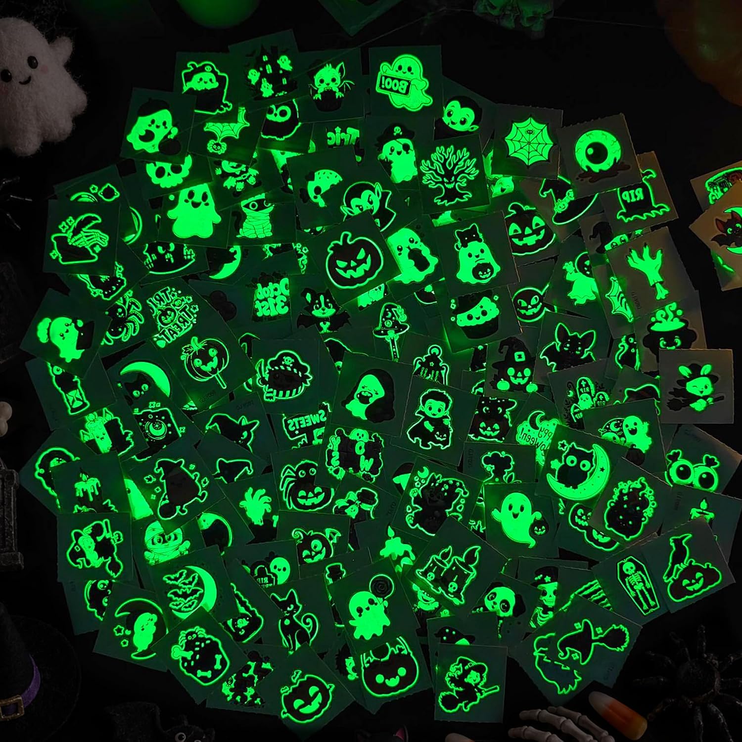 An assortment of Halloween tattoo designs shown glowing in a dark setting
